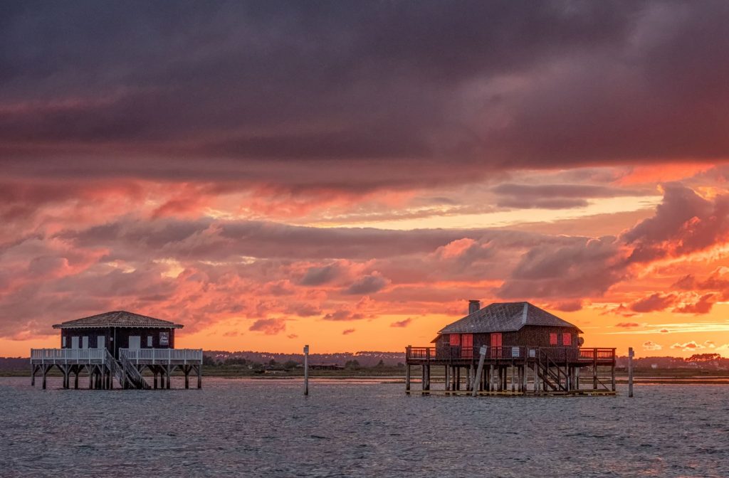 Nuages roses au-dessus des cabanes Tchanquées, au milieu du Bassin d'Arcachon